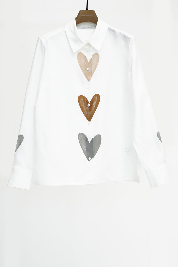 White shirt with heart-shaped buttons on a white background