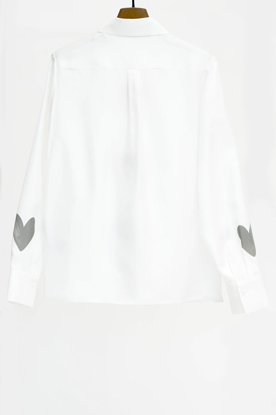 White shirt with gray heart designs on a white background