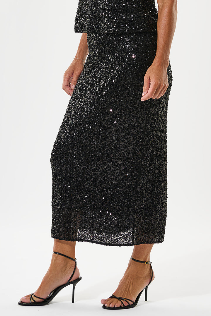 Black sequin dress worn by a person on a white background