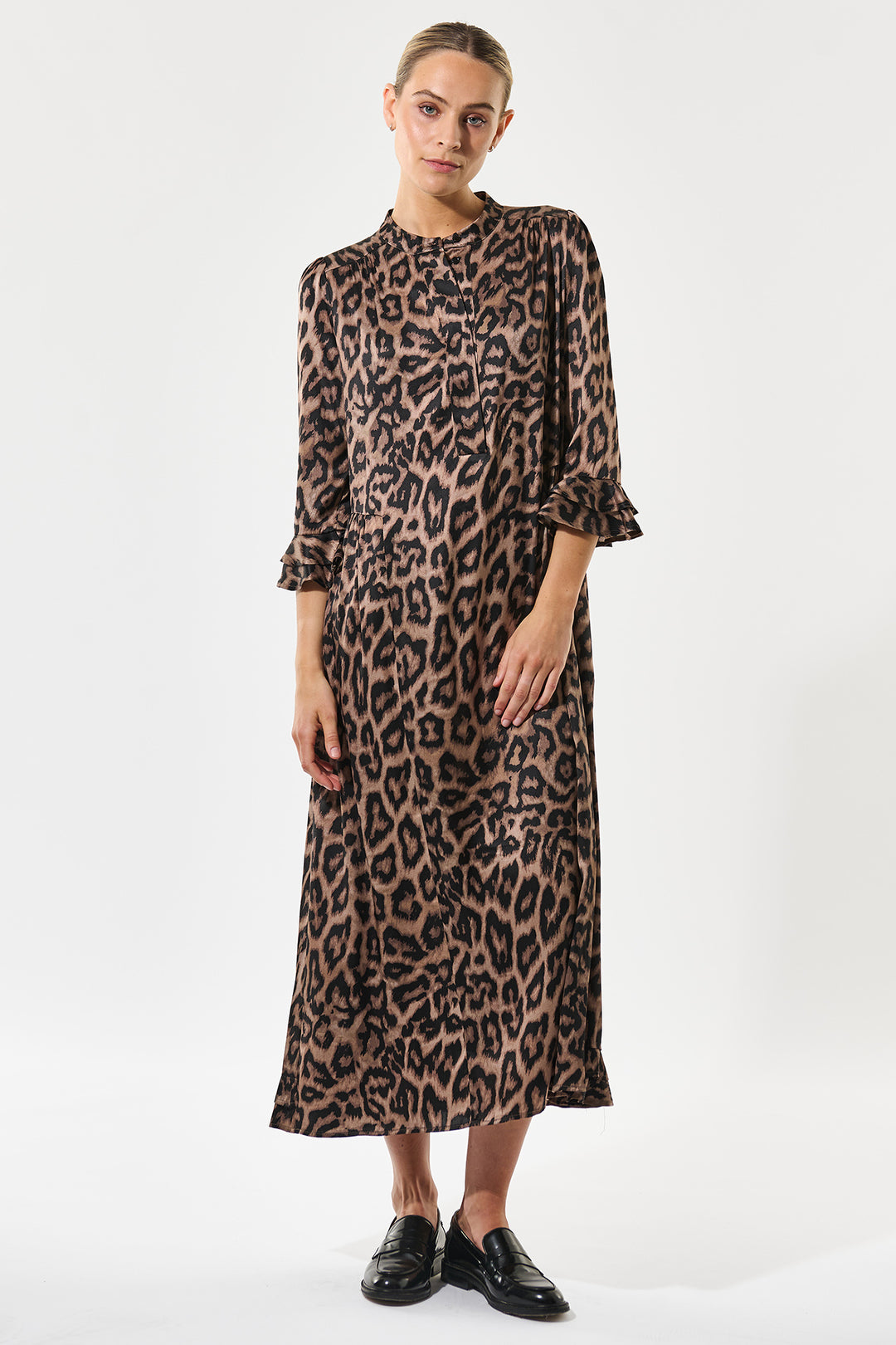 Woman wearing a leopard print dress on a white background