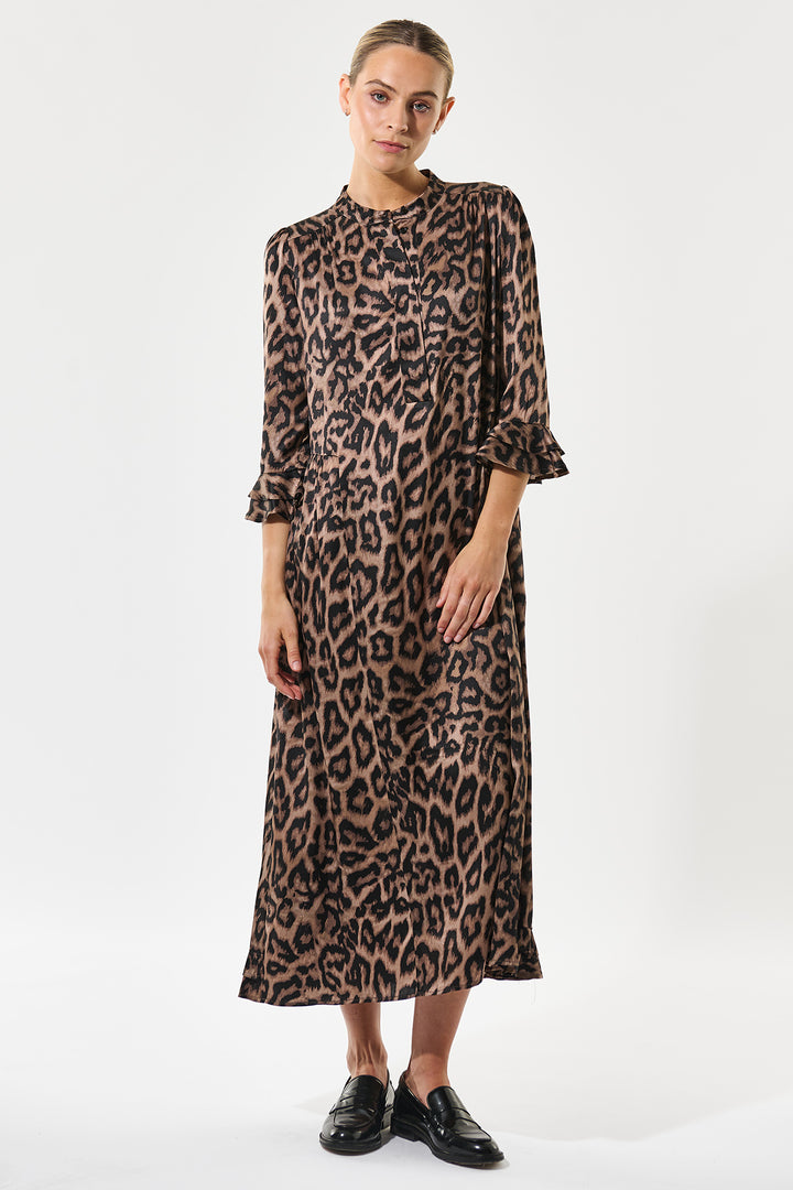 Woman wearing a leopard print dress on a white background