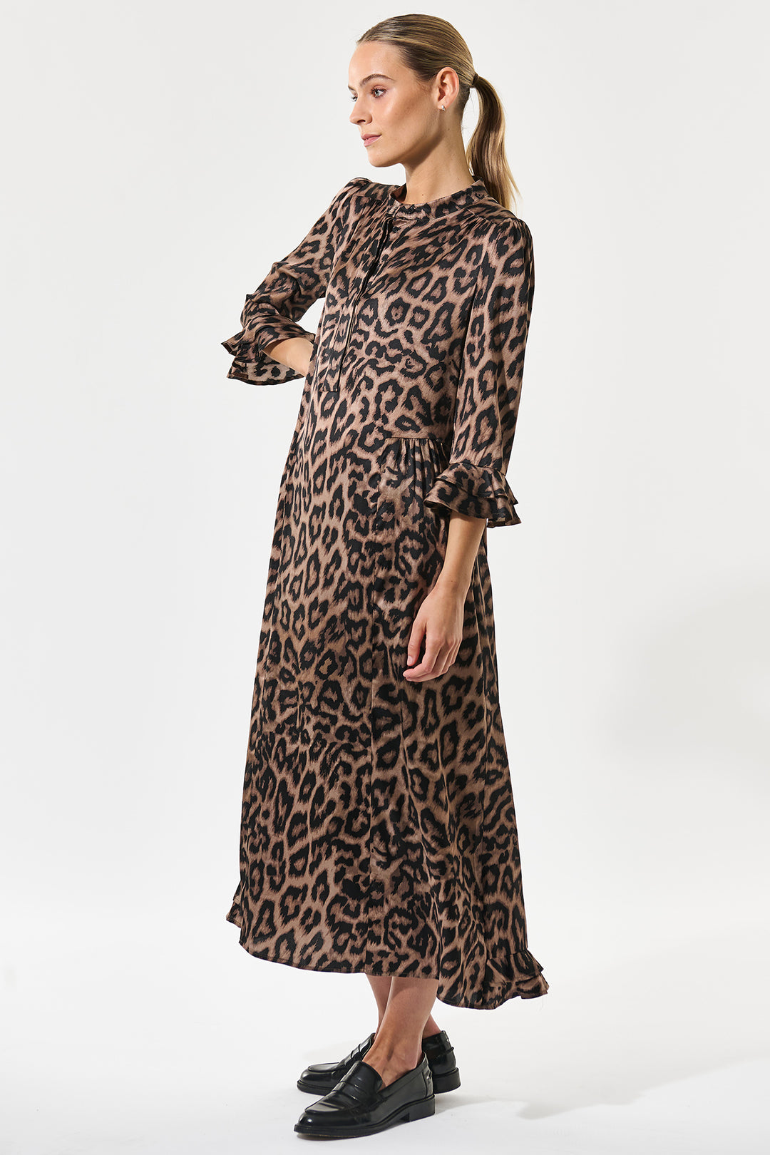 Woman wearing a leopard print dress on a white background