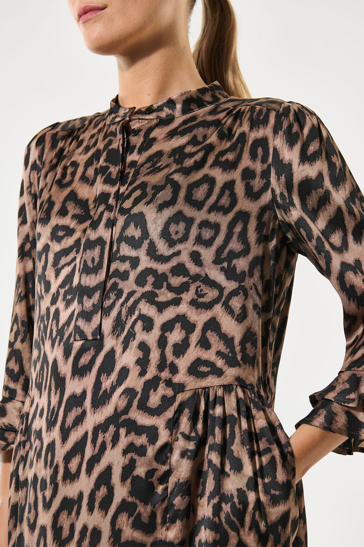 Leopard print dress worn by a person on a plain background