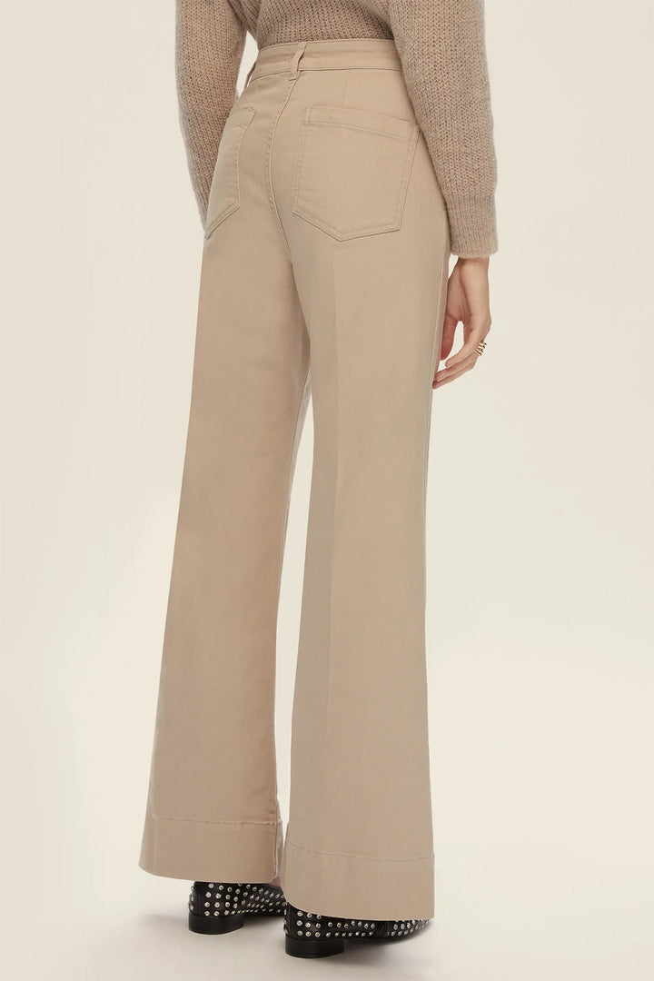 Beige wide-leg pants worn by a person on a beige background