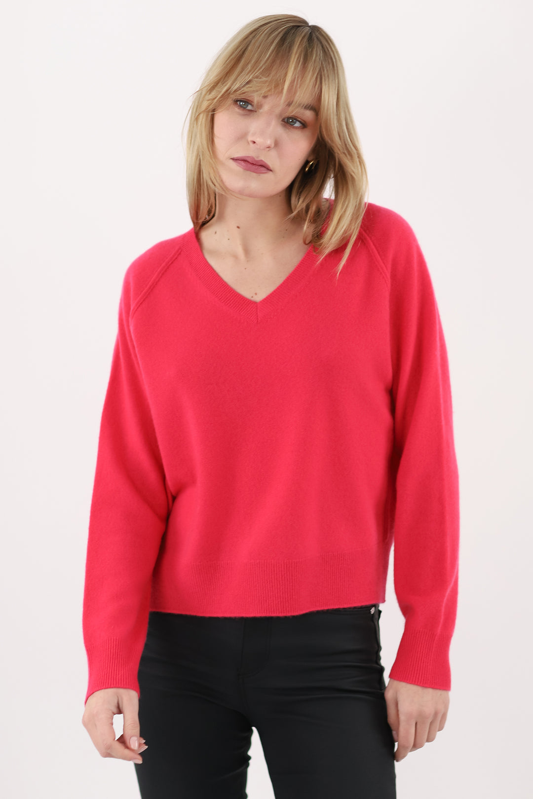 Woman wearing a pink sweater on a white background