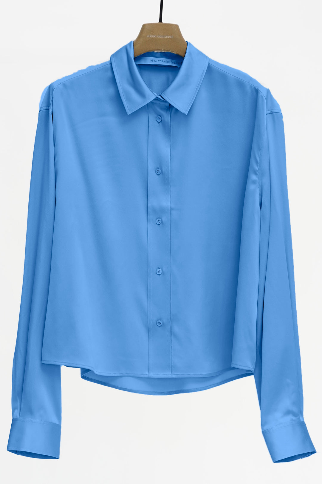 Blue shirt on a hanger against a white background