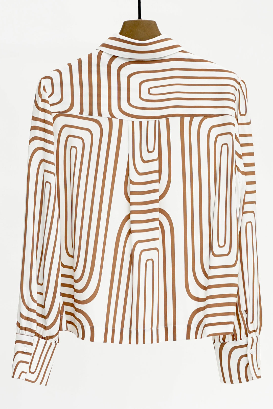 Mannequin wearing a shirt with brown abstract pattern on a white background