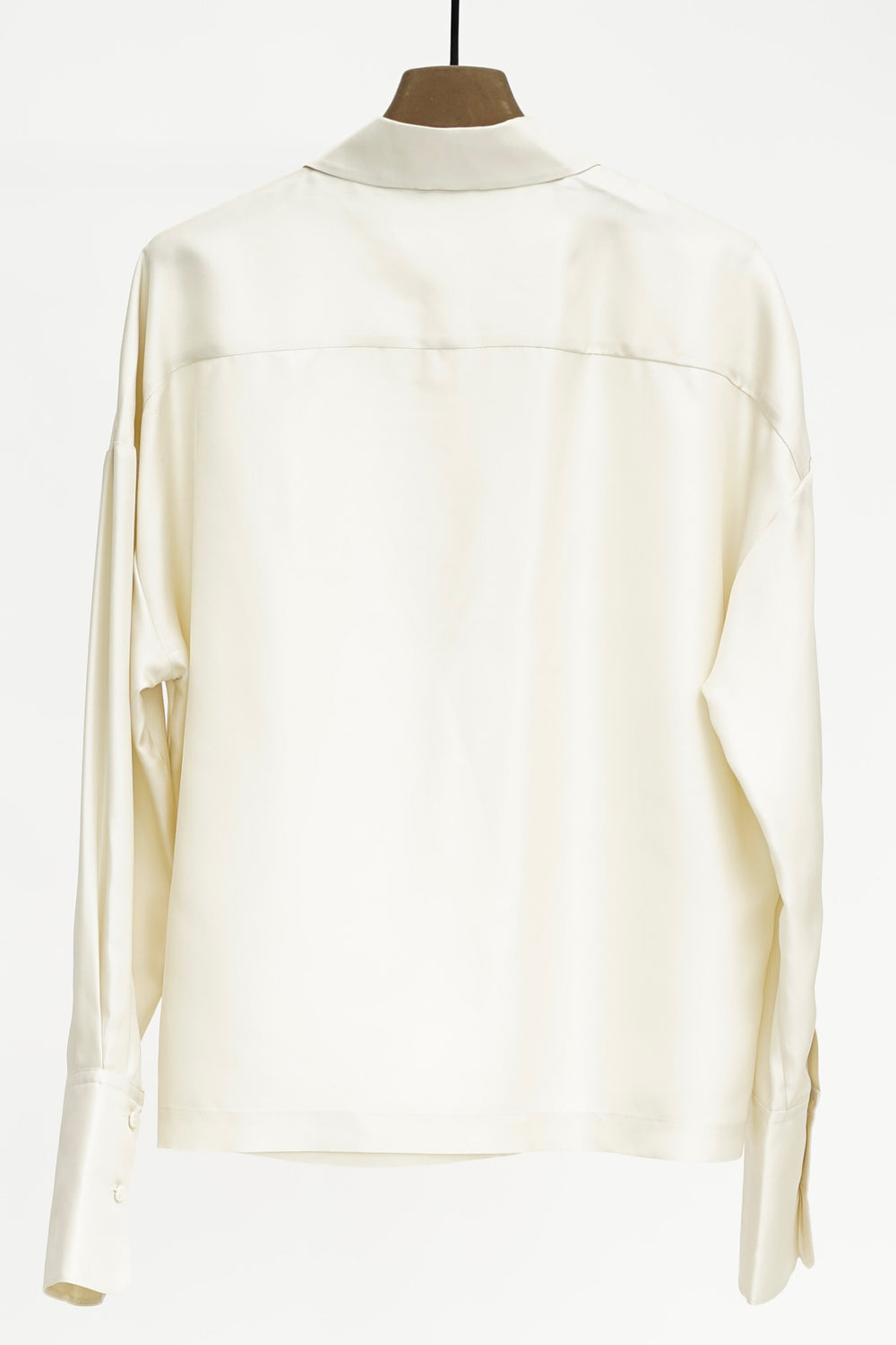 Cream blouse on a mannequin against a white background