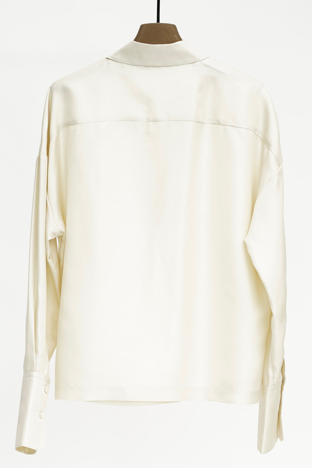 Cream blouse on a mannequin against a white background