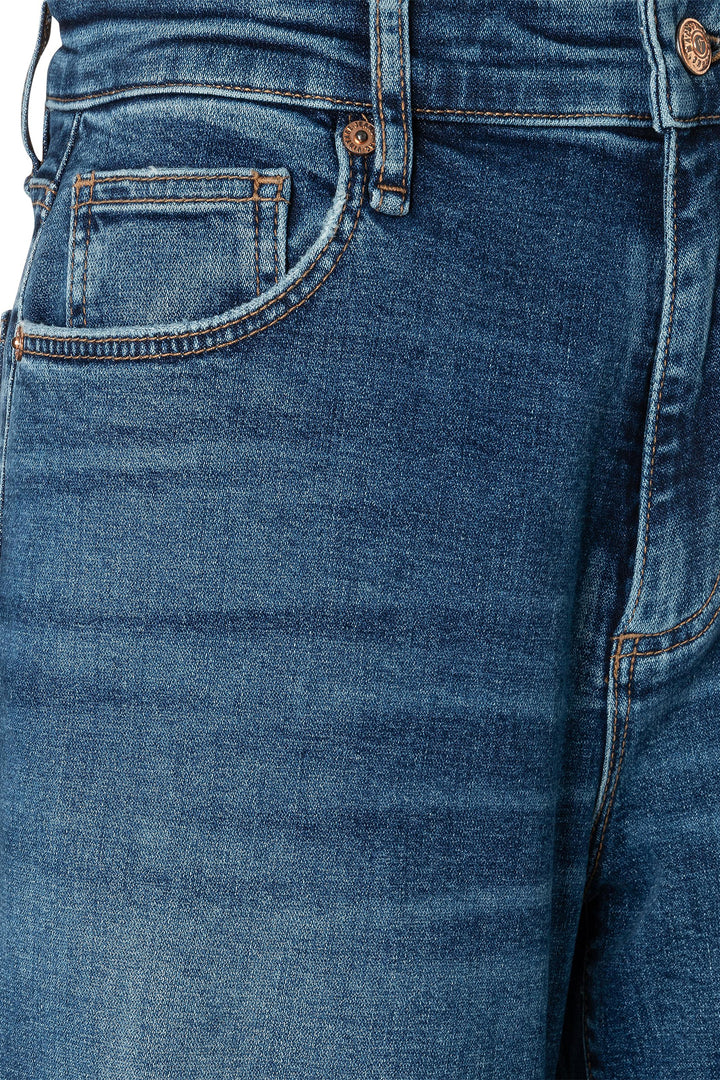 Close-up of blue jeans with a focus on the pocket and stitching.
