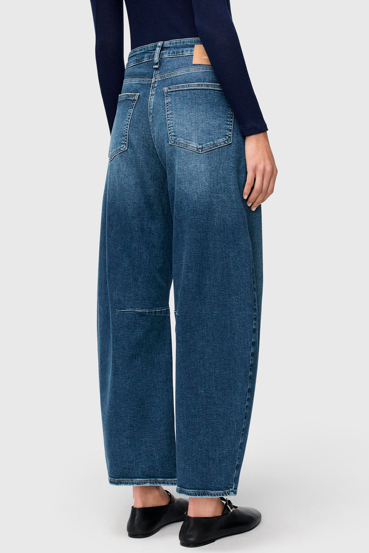 Person wearing blue jeans on a white background