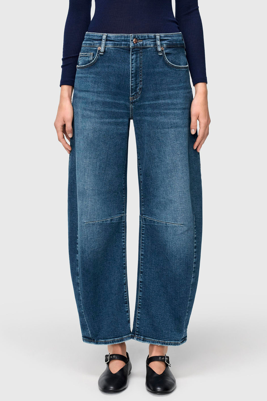 Person wearing blue jeans on a white background