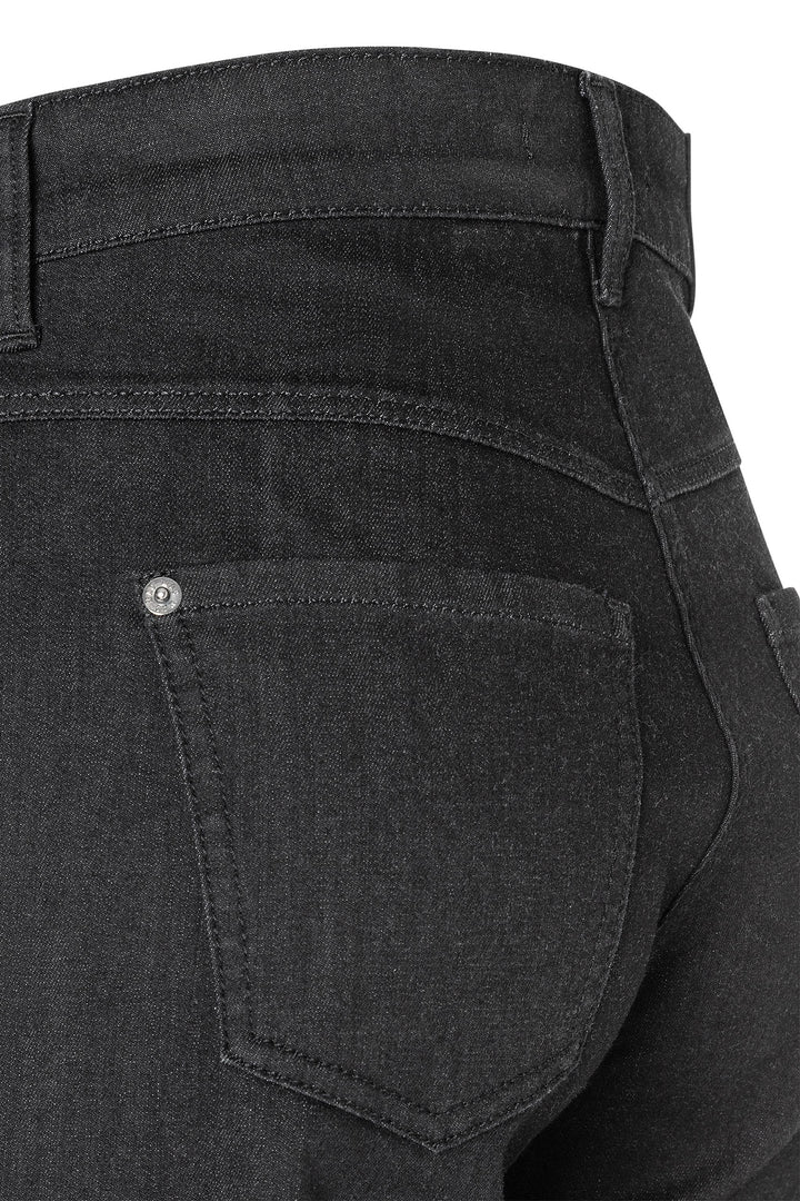 Close-up of black jeans with a focus on the back pocket.