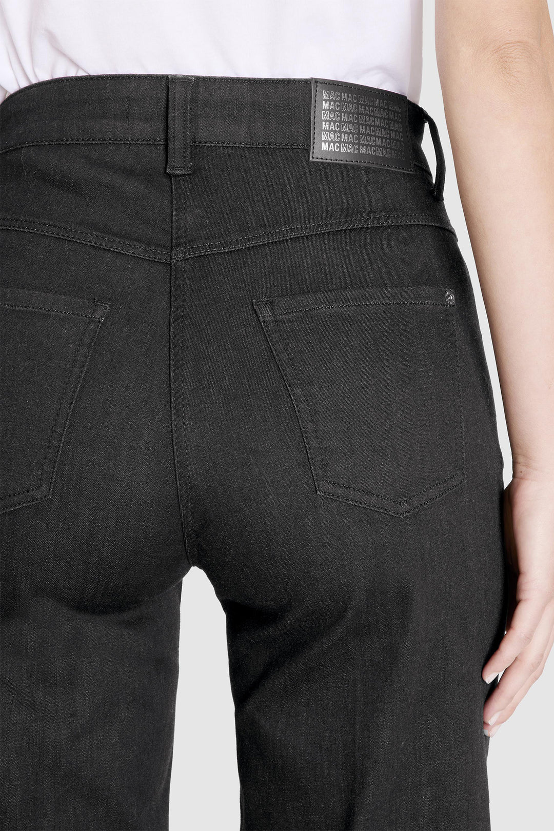 Black pants with a visible brand label on a white background