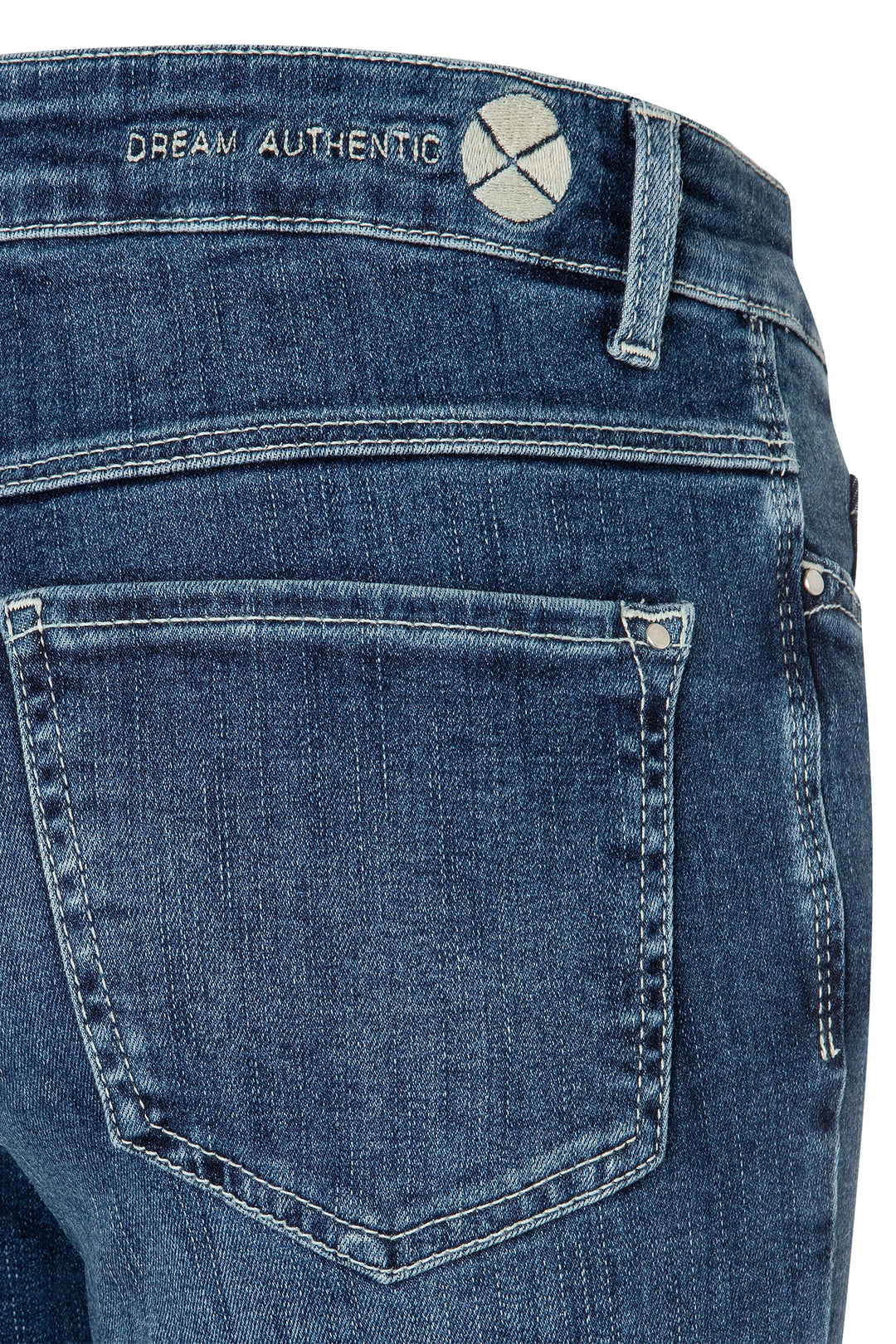 Close-up of blue jeans with 'Dream Authentic' branding on a white background
