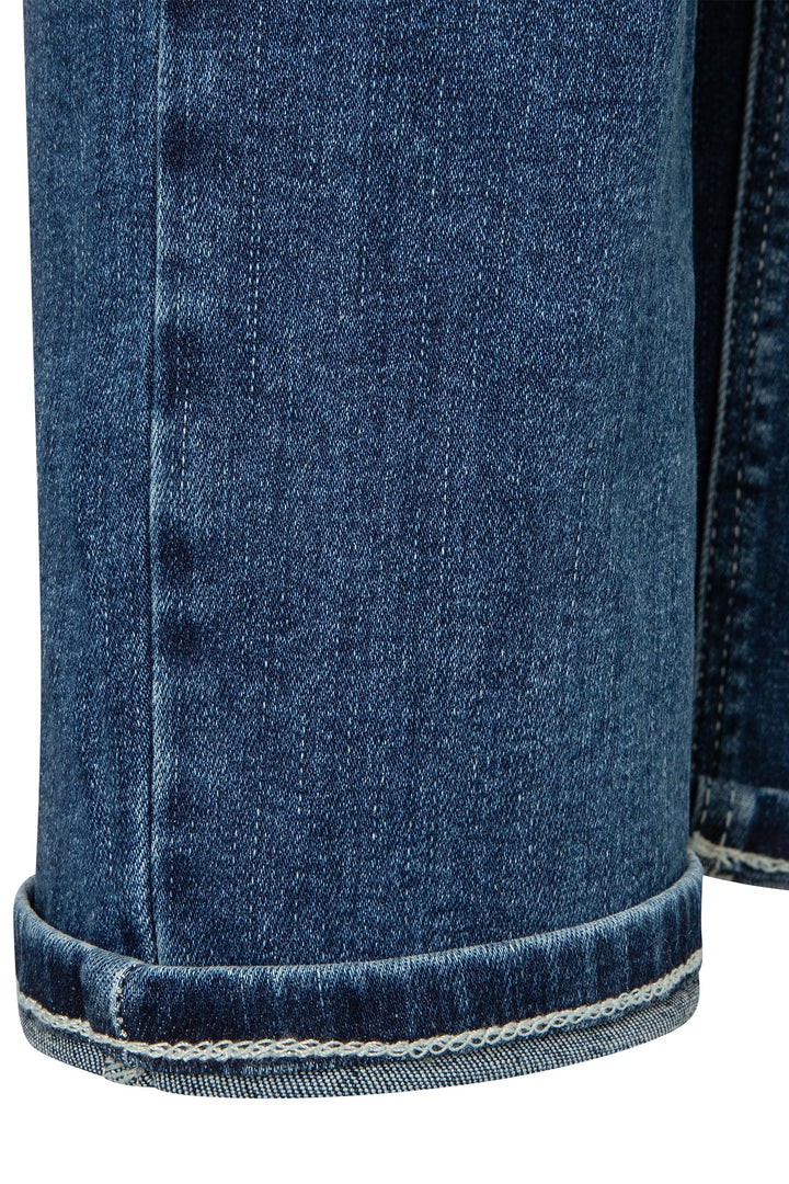 Close-up of blue denim fabric with a visible stitching detail.