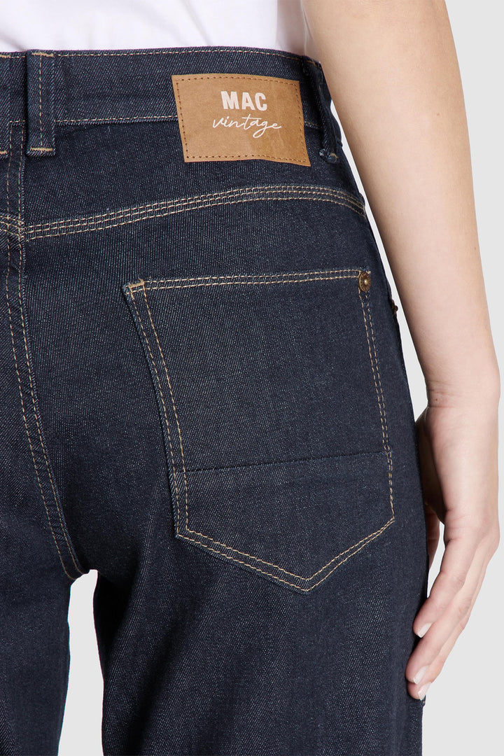 Dark blue jeans with a visible brand label on a white background