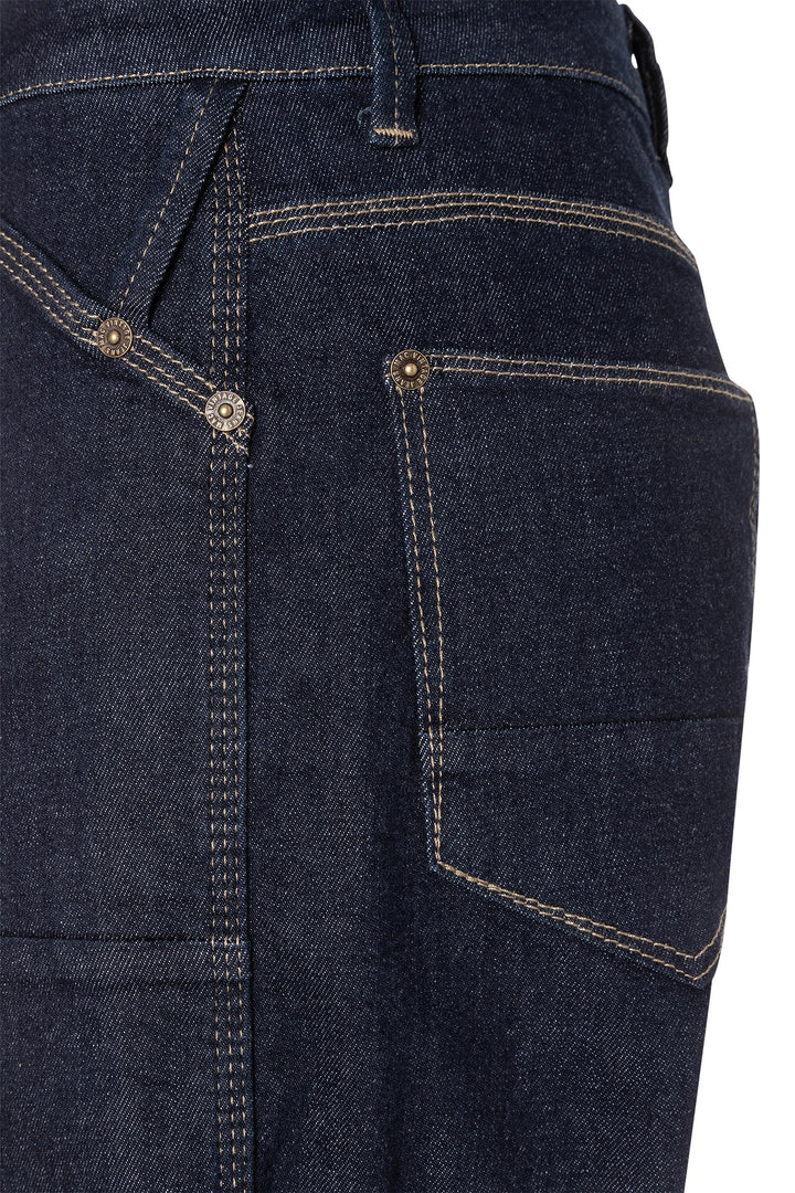 Close-up of dark blue jeans with stitching details on a white background