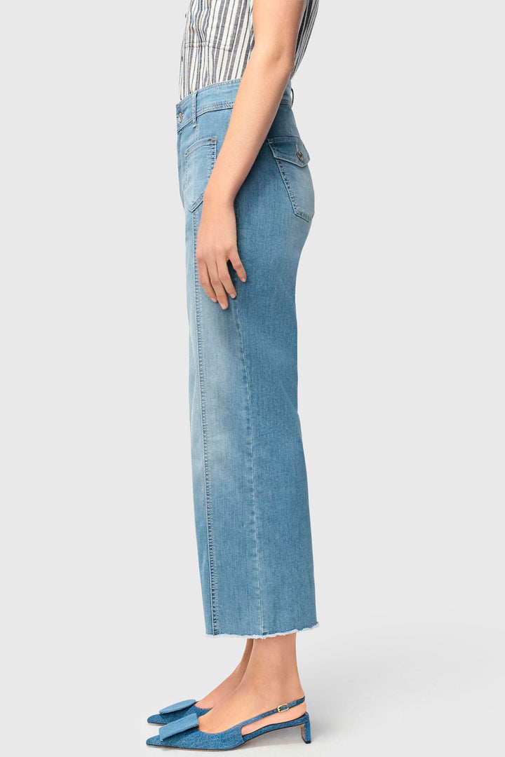 Person wearing blue jeans on a white background