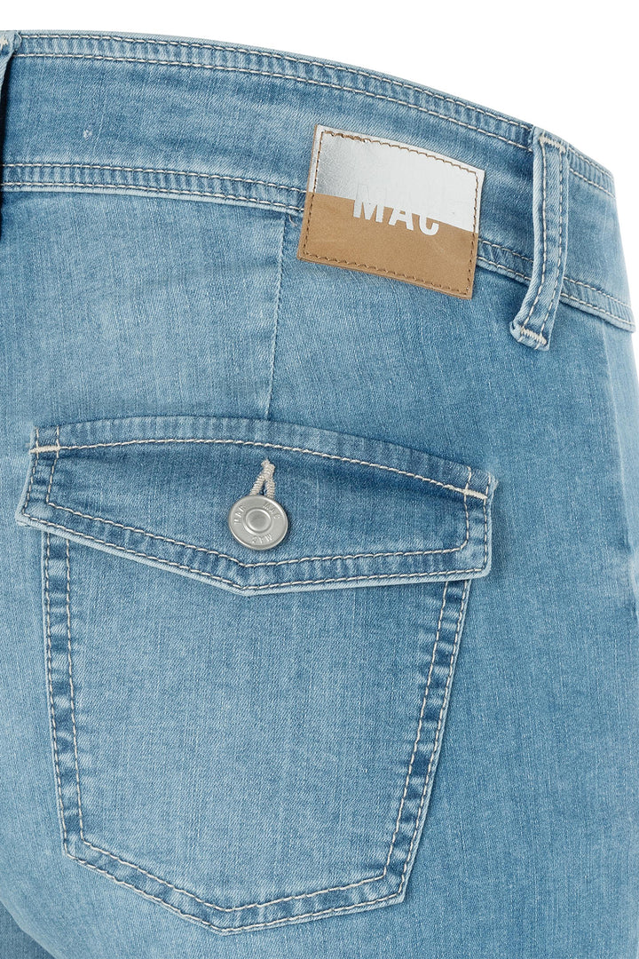 Close-up of blue denim jeans with a brand label on the pocket.