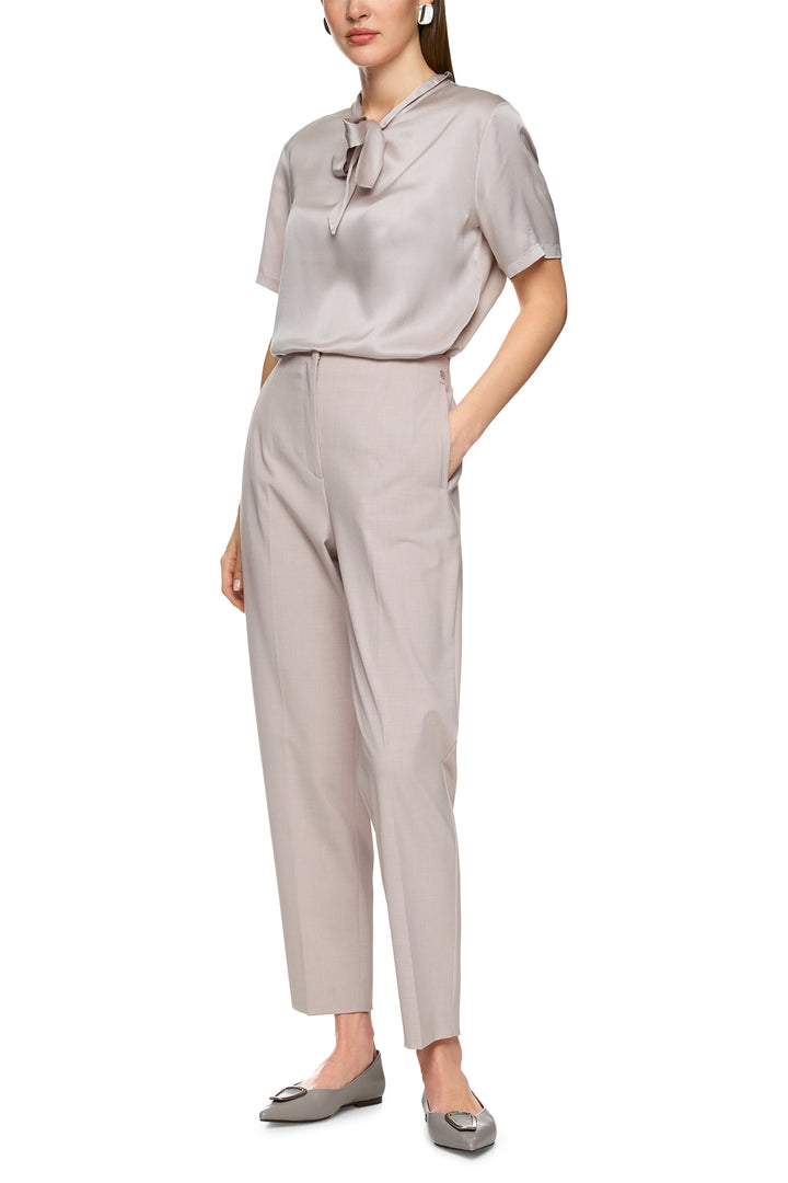 Woman wearing a light gray outfit on a white background