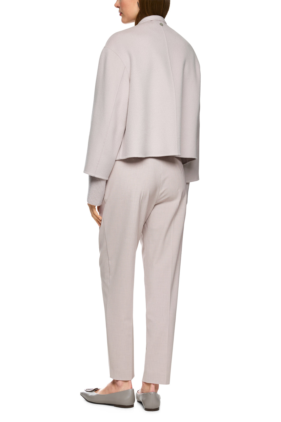 Person wearing a light gray suit on a white background