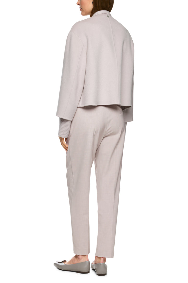 Person wearing a light gray suit on a white background