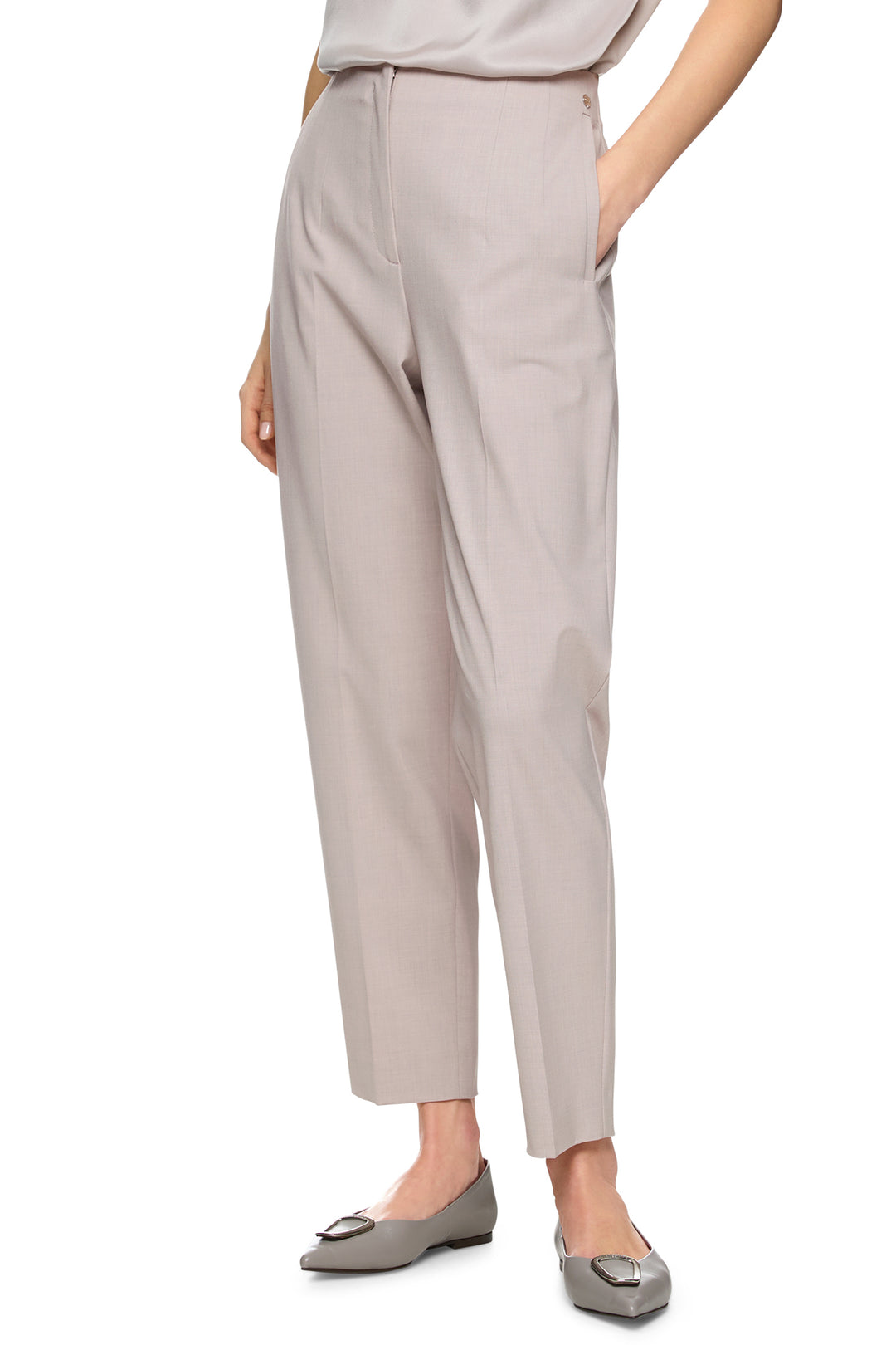 Beige pants worn by a person on a white background