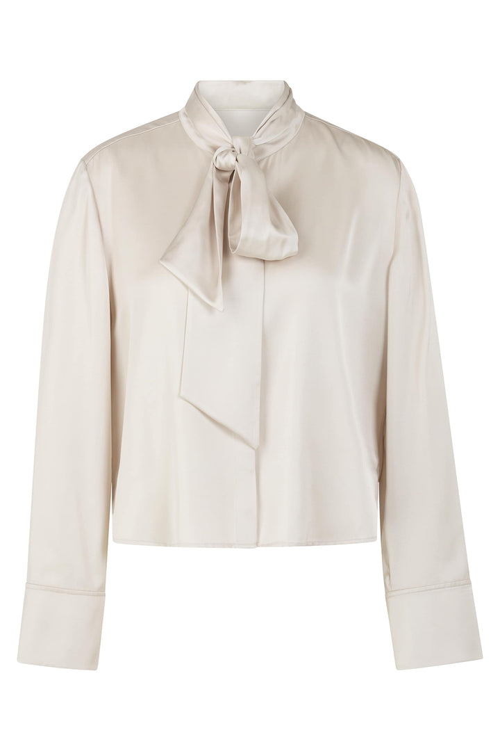 Beige blouse with a bow tie on a white background
