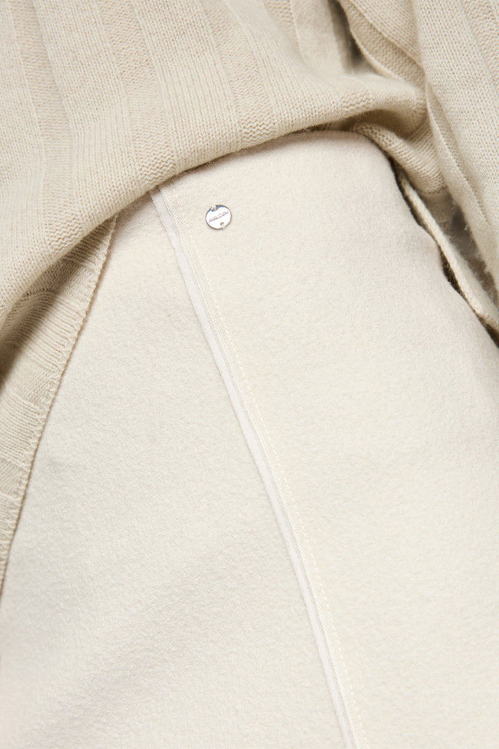 Close-up of a beige garment with a brand label.