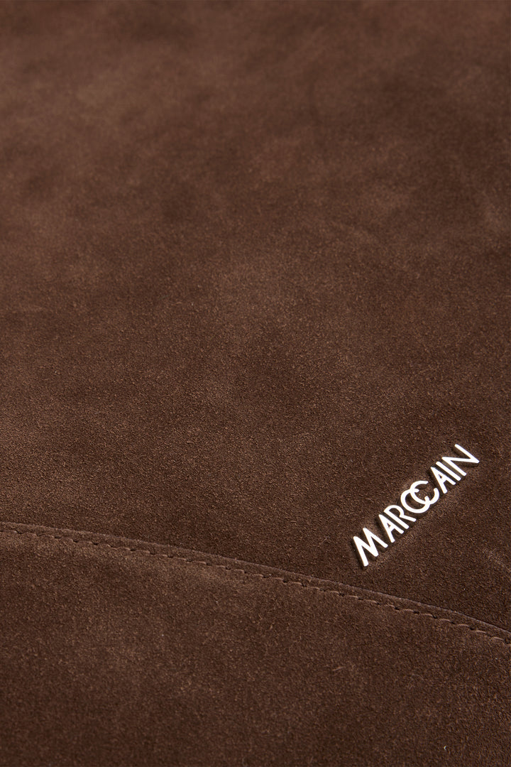 Brown textured fabric with 'Marc Cain' branding