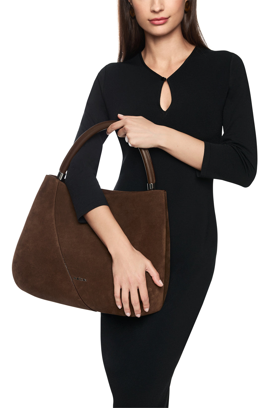 Woman holding a brown handbag against a white background