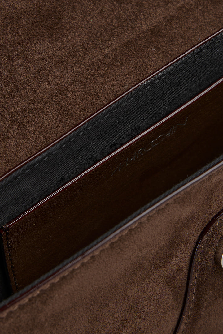Close-up of a brown leather bag with visible stitching