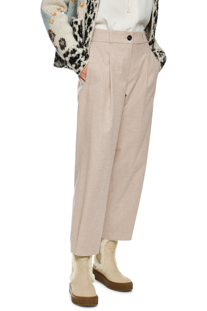 Beige pants worn by a person on a white background