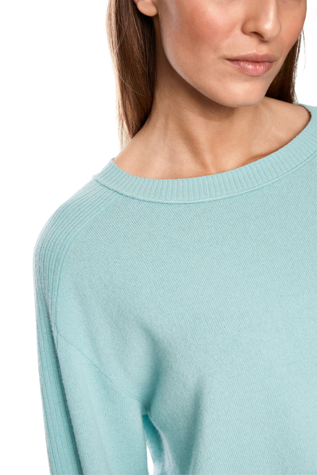 Light blue sweater worn by a person on a white background