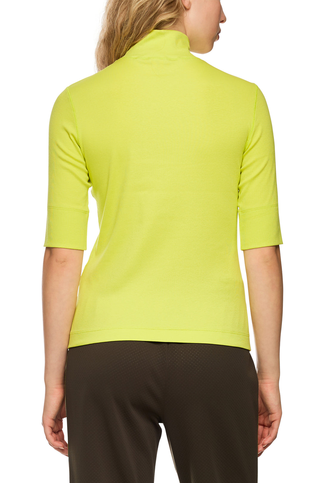 Person wearing a bright green shirt with a white background