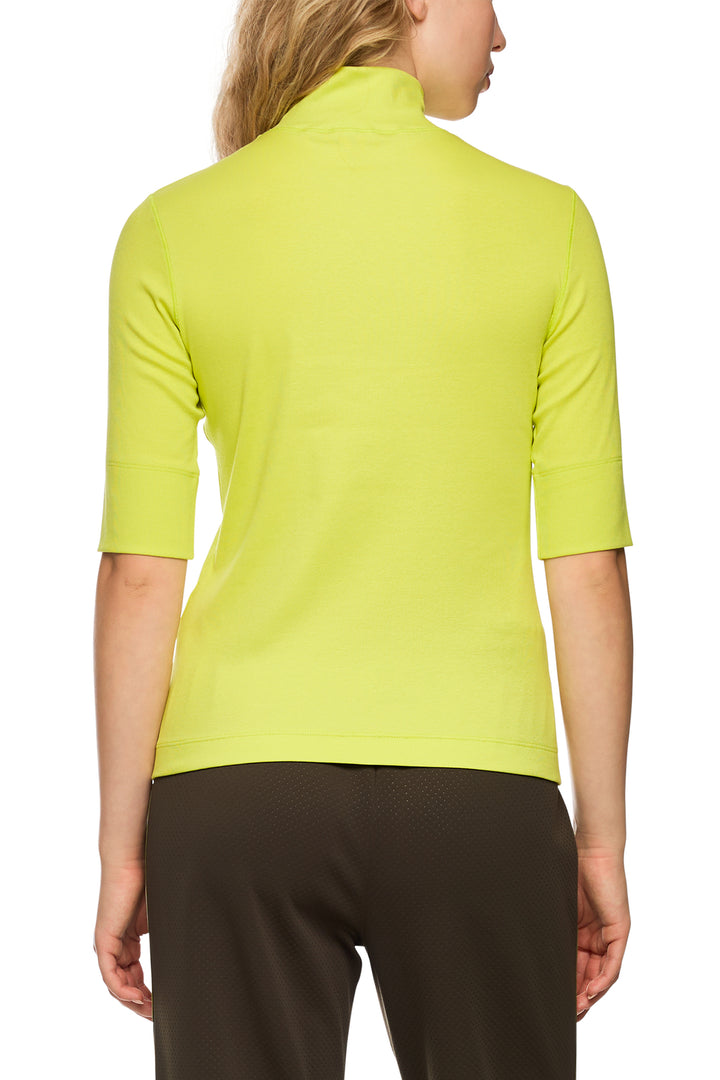 Person wearing a bright green shirt with a white background