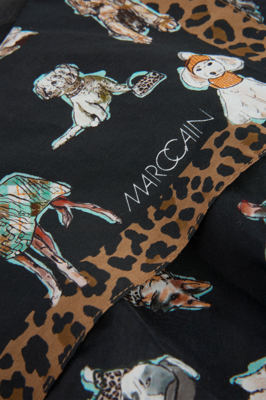 Textile with dog and leopard print pattern and 'Marc Cain' branding.