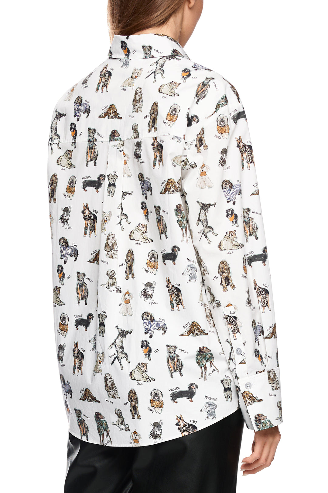 Person wearing a white shirt with dog pattern on a white background