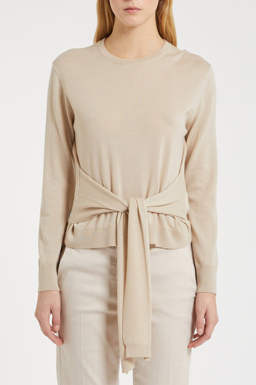 Beige long-sleeve top with a tie detail worn by a person on a white background
