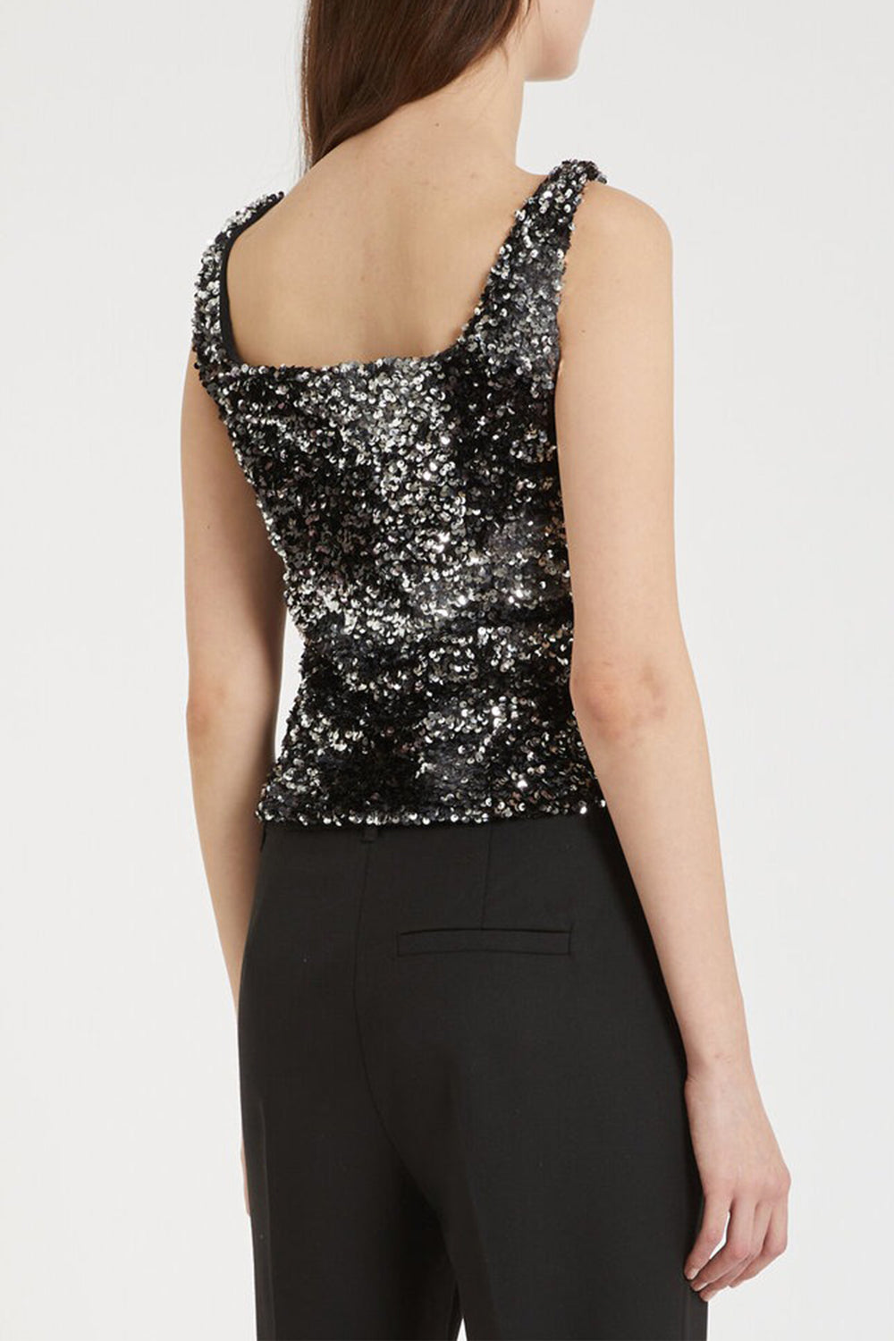 Black sequin top worn by a person on a white background