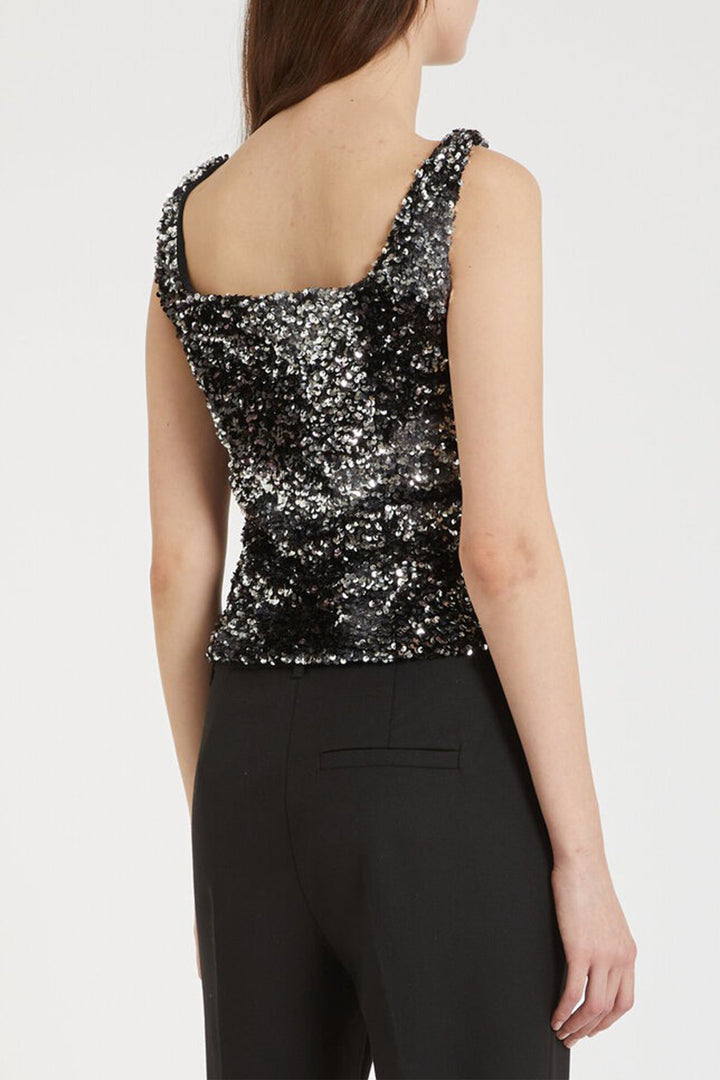 Black sequin top worn by a person on a white background