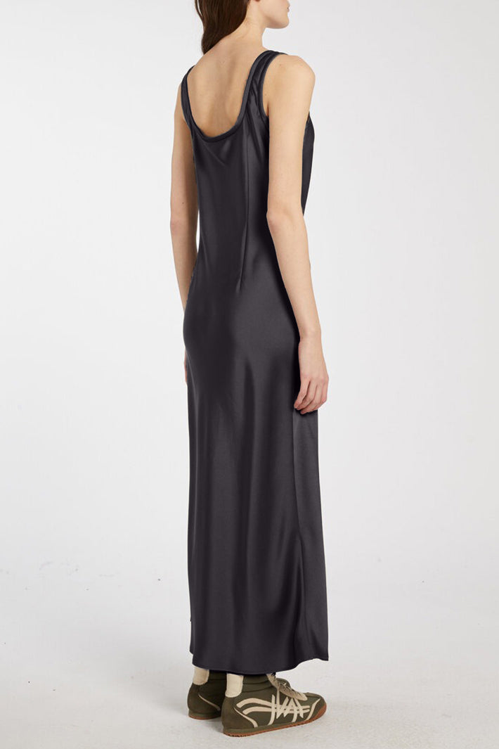 Person wearing a long black dress on a white background