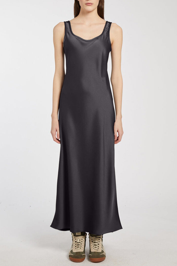 Person wearing a long dark gray dress on a white background