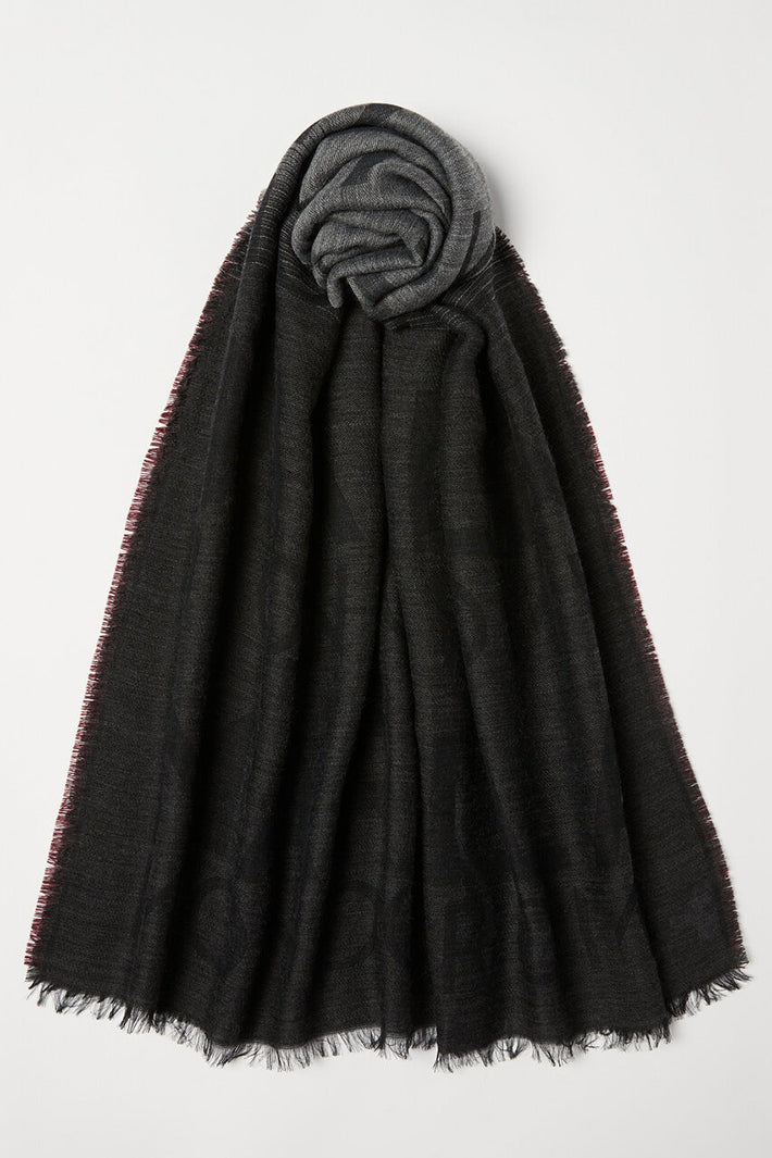 Dark gray scarf with frayed edges on a white background