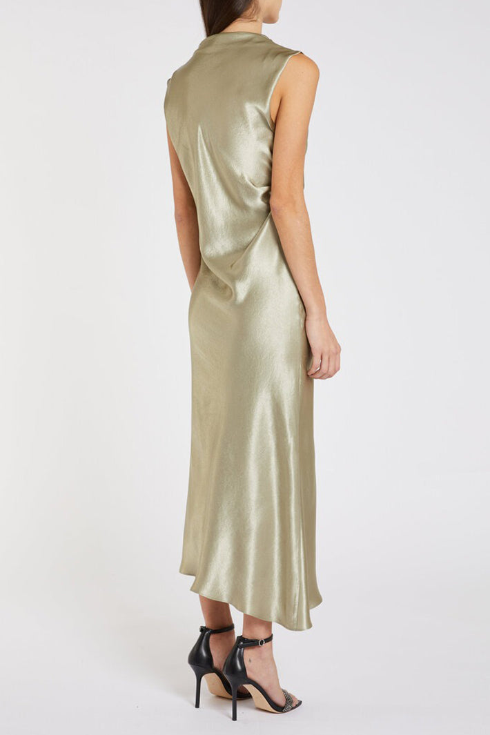 Woman wearing a sleeveless, light green satin dress on a white background