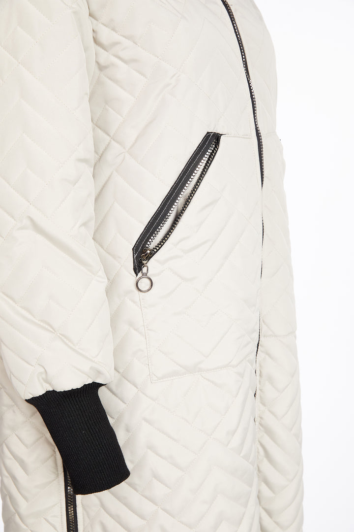Taupe quilted jacket with a black zipper on a white background