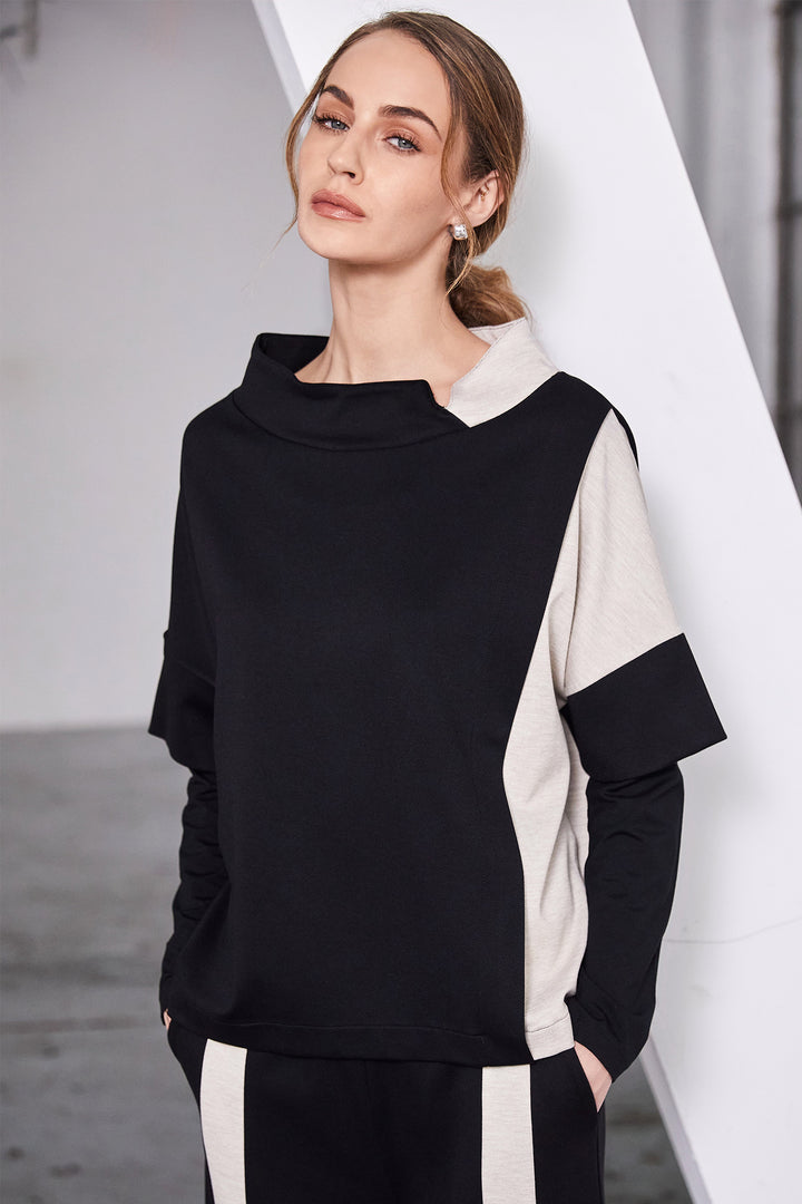 Woman wearing a black and white outfit with a blurred background