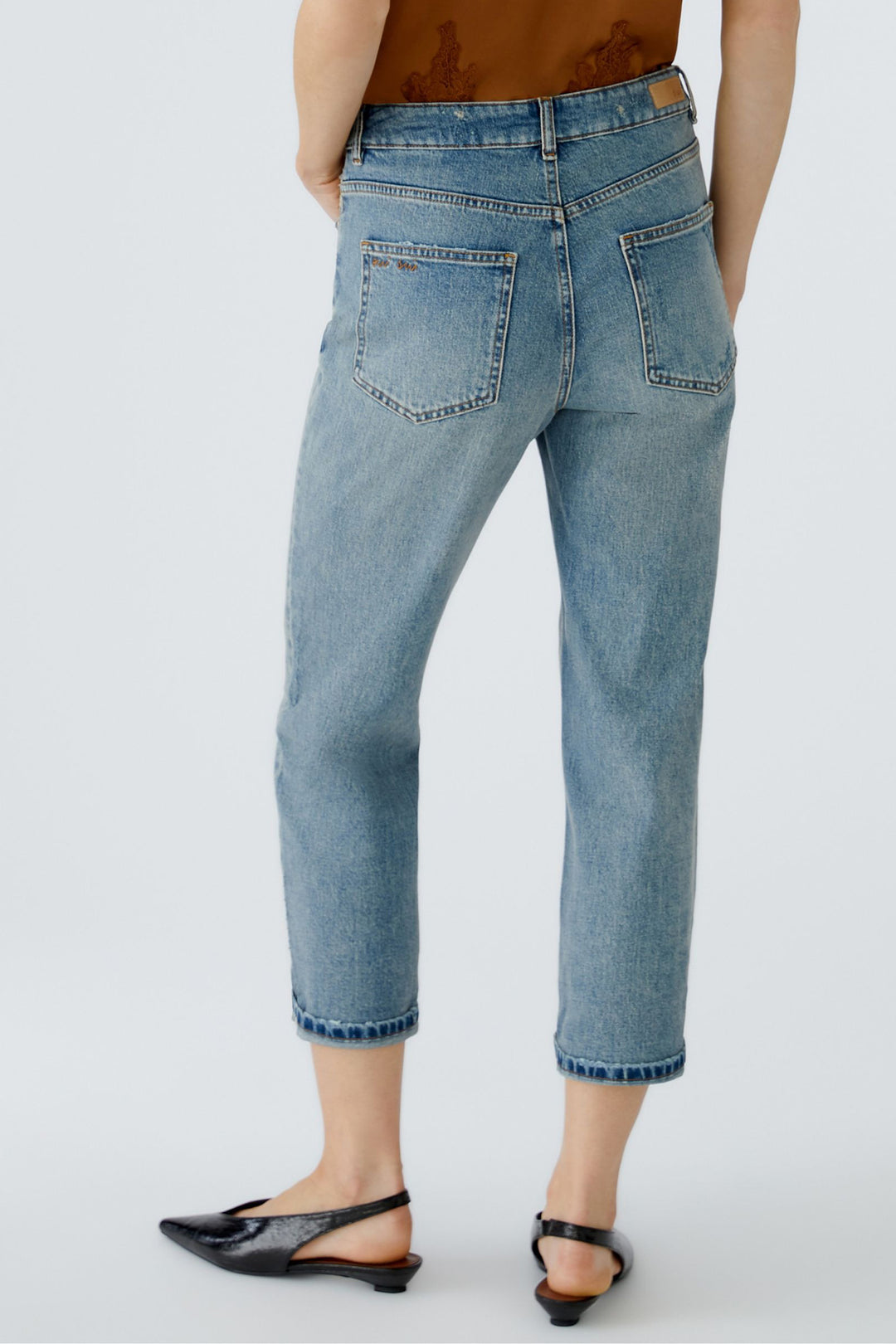 Light blue jeans worn by a person on a white background