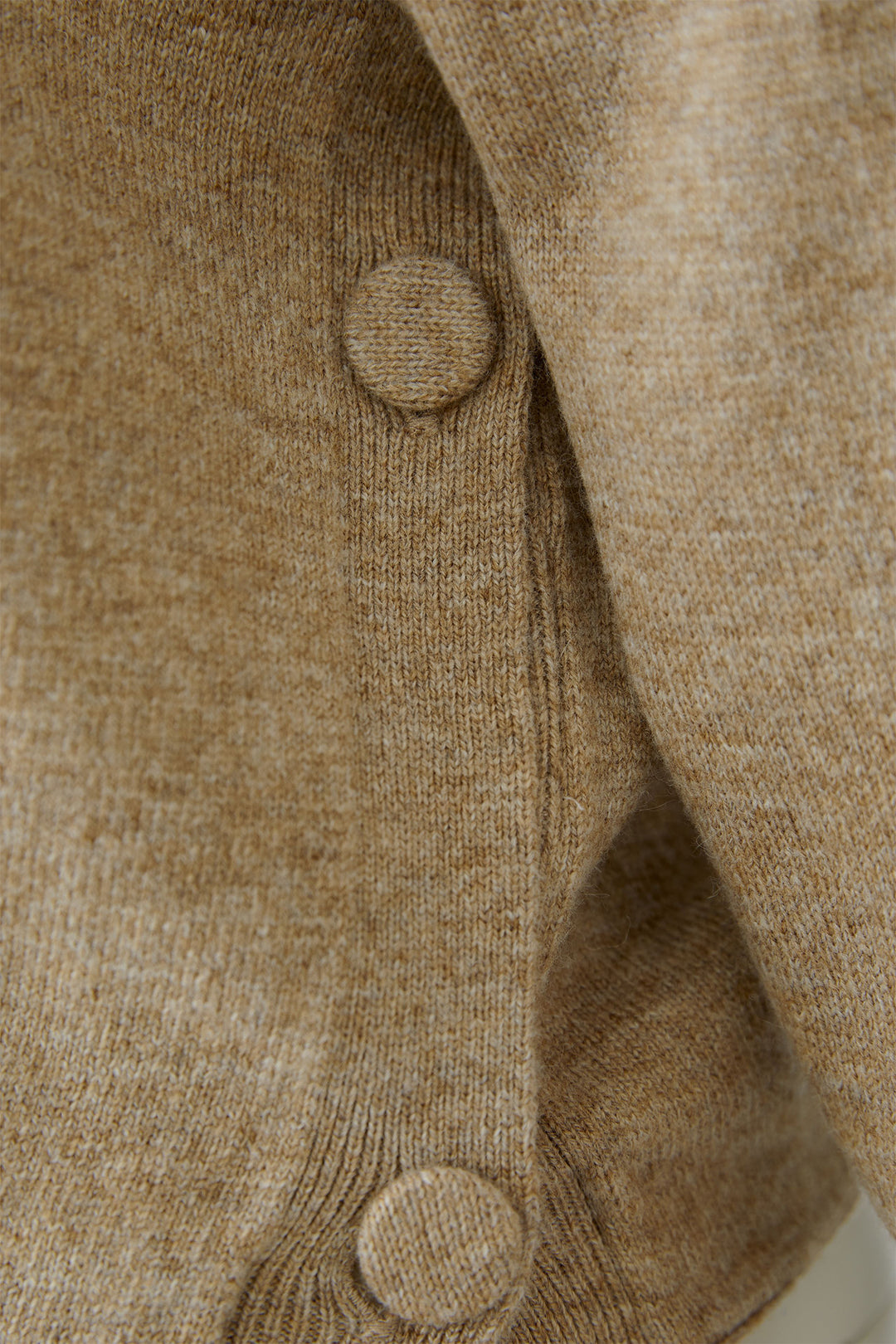 Close-up of a beige textured fabric with buttons